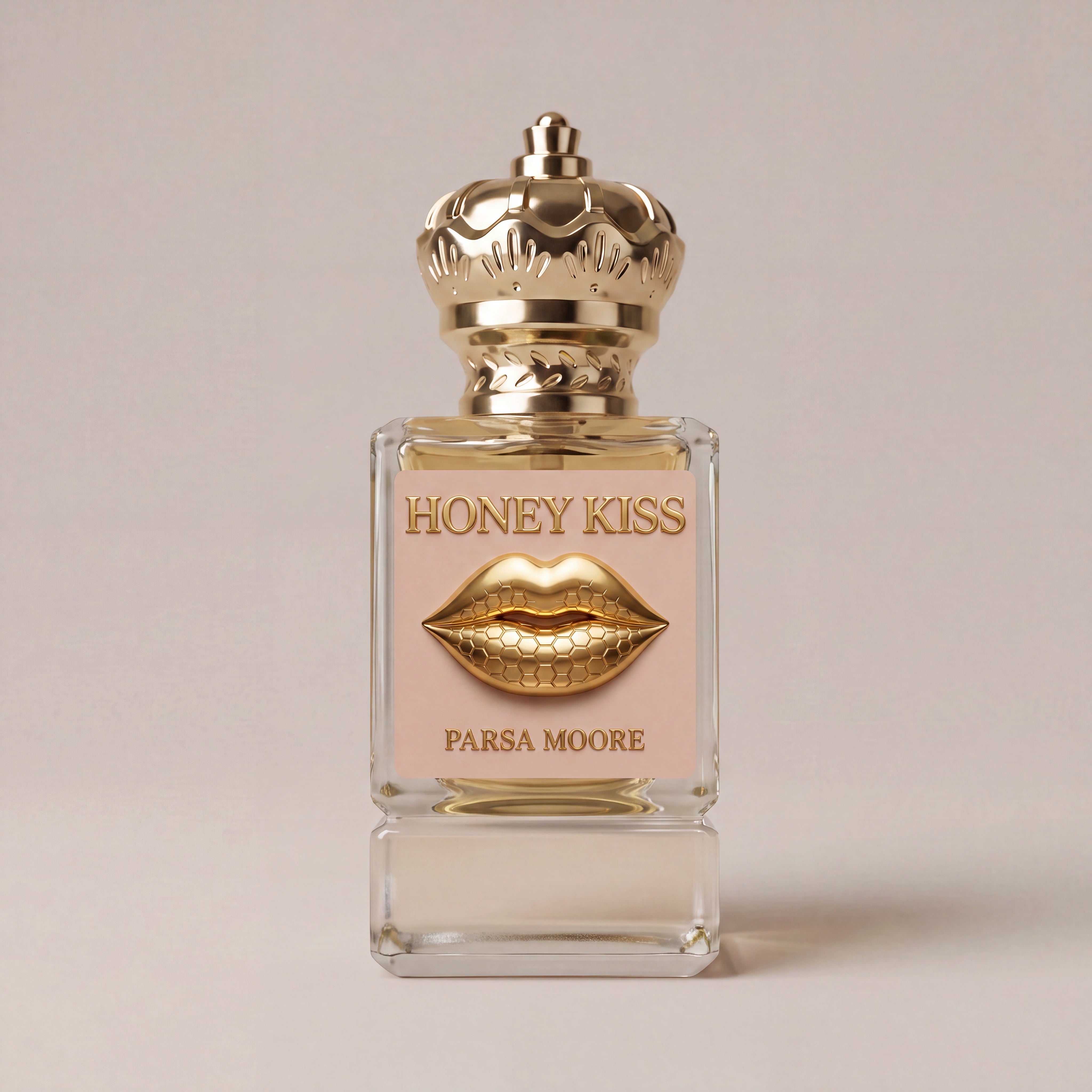 A rectangular glass perfume bottle with a gold crown cap, featuring a pale pink label with 'HONEY KISS' and 'PARSA MOORE' in gold text, plus a gold lips graphic in the center, set against a solid light beige background.
