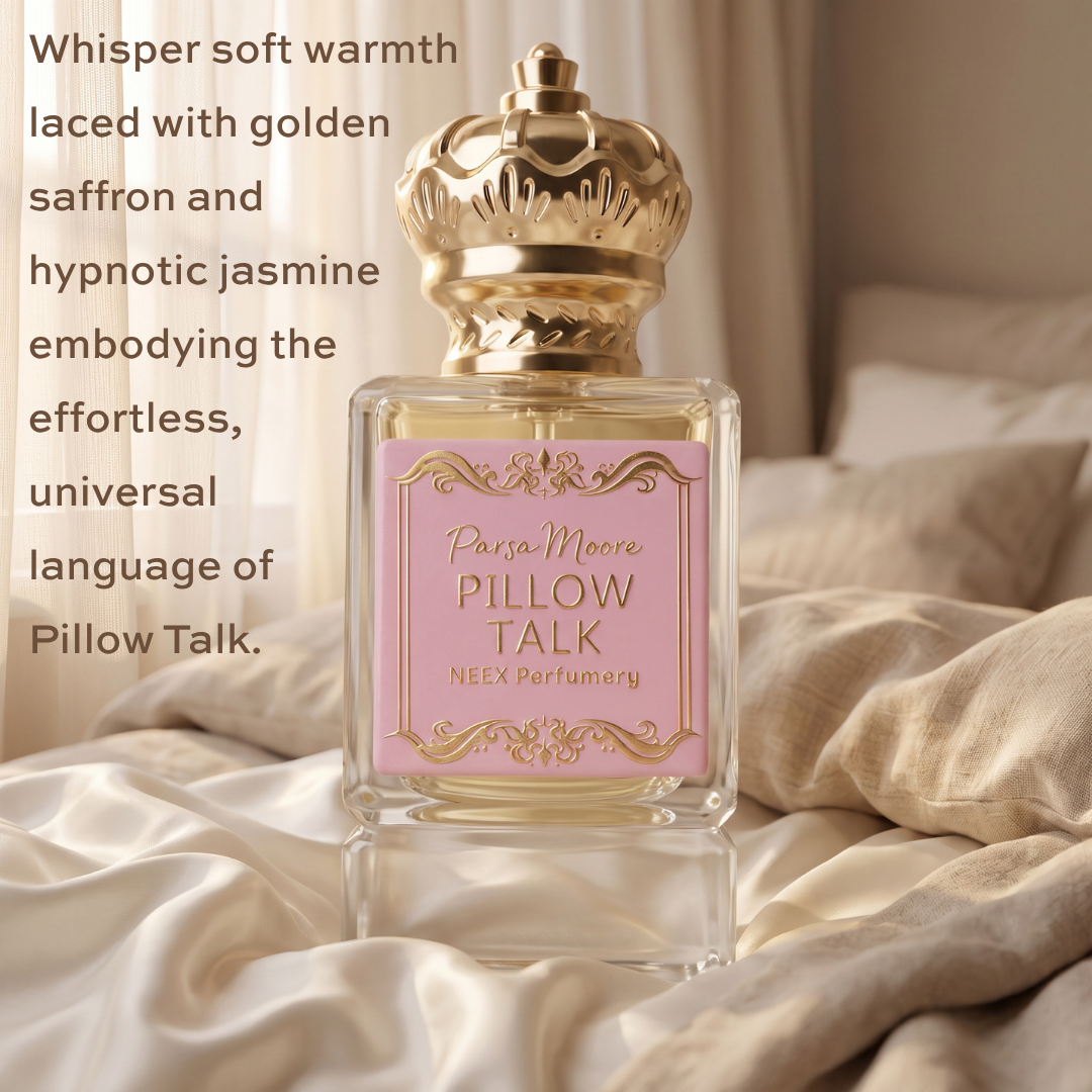 A perfume bottle labeled 'Parsa Moore Pillow Talk' by NEEX Perfumery, featuring a pink label and ornate gold cap, set on a bed with cream-colored bedding and soft sunlight filtering through curtains. Text on the left describes the scent notes.