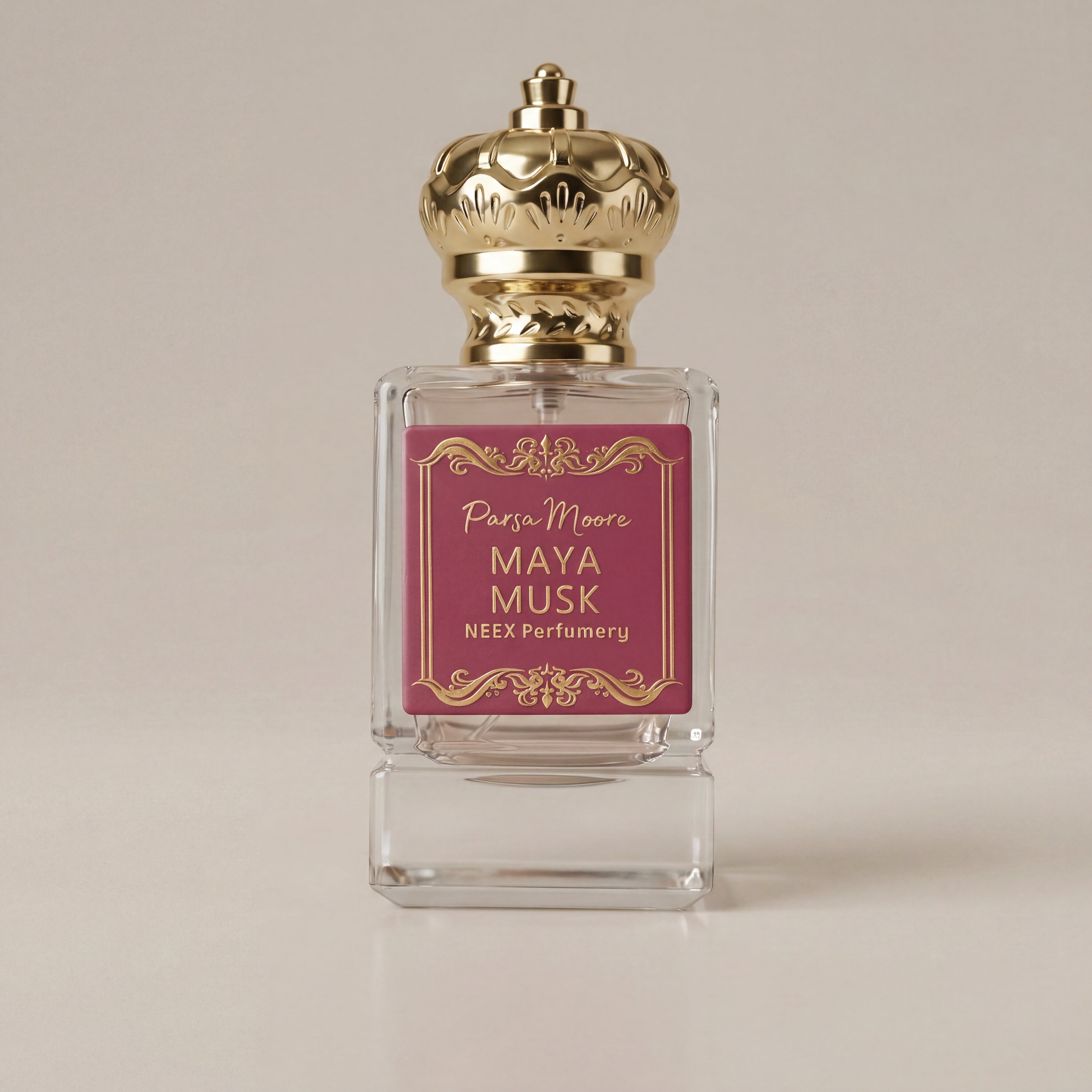 Perfume bottle with gold cap and pink label on a beige background
