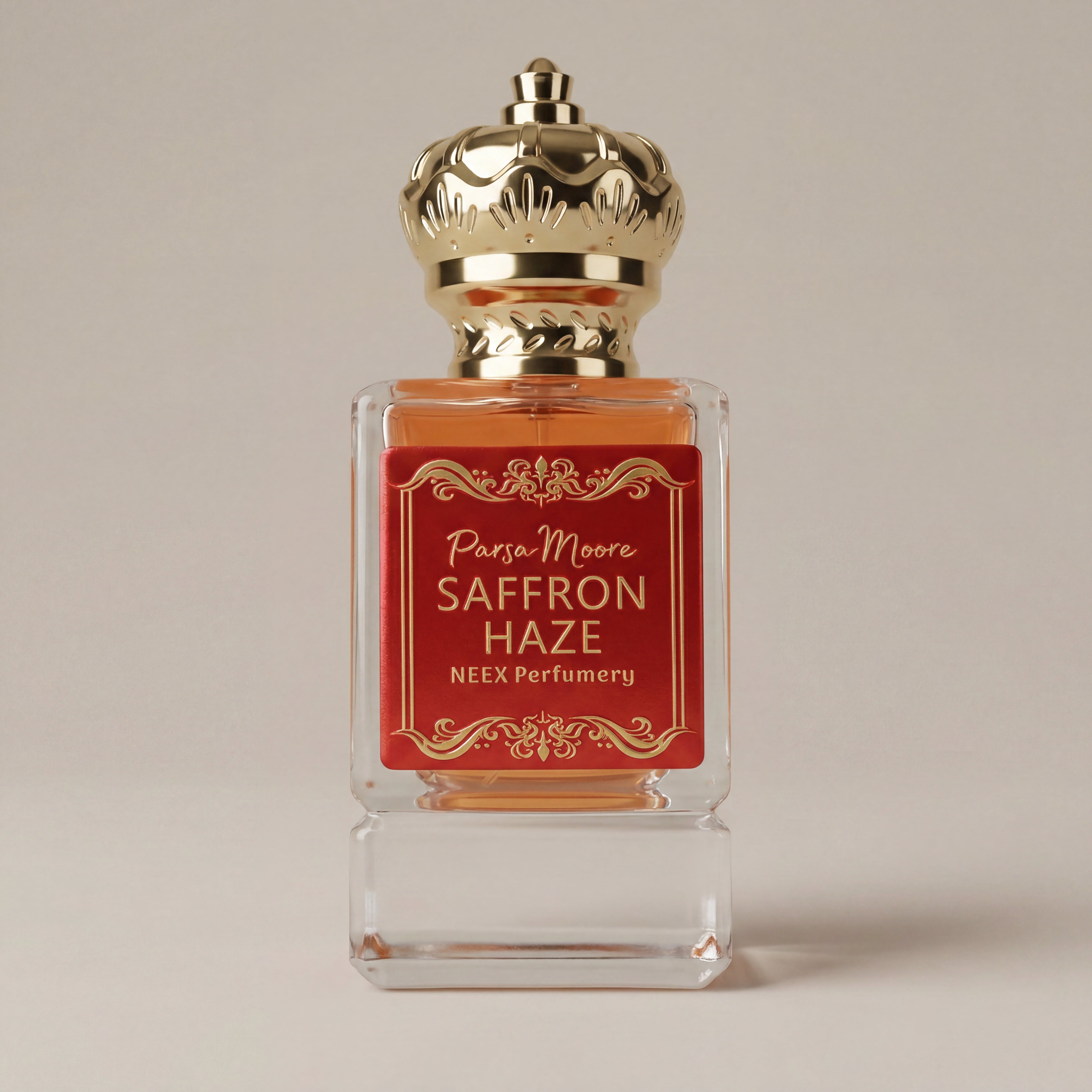 Perfume bottle with gold cap and red label on a beige background